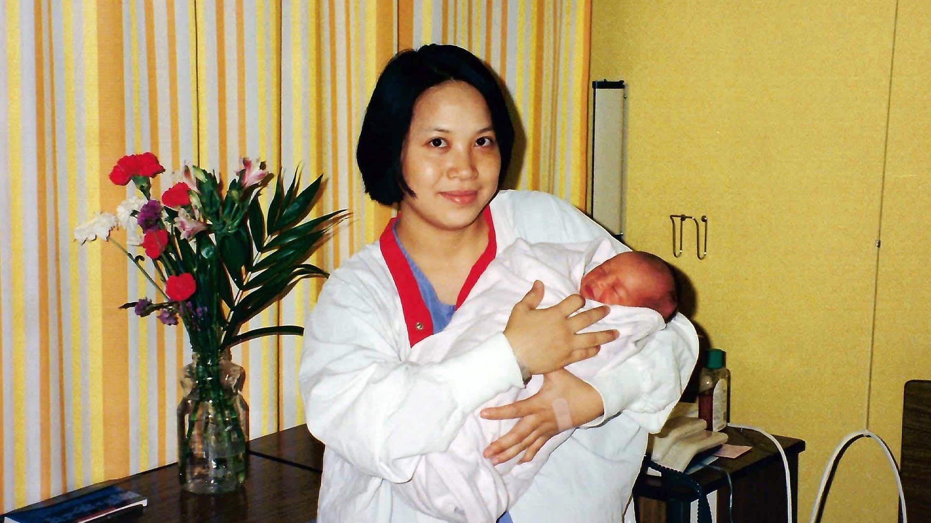 Elaine Kan with newborn Carol.