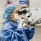Your Impact on Cancer Care at North York General. Staff looking through a microscope at North York General